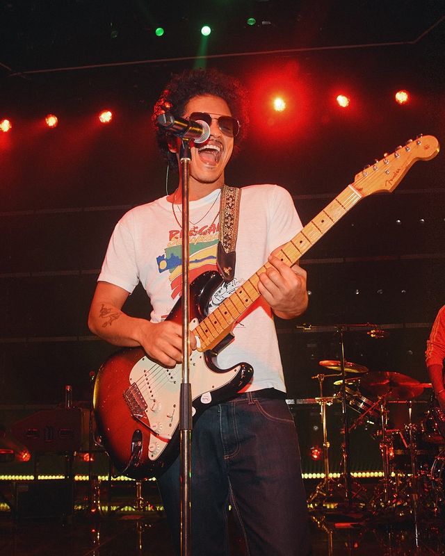 Bruno Mars playing guitar.