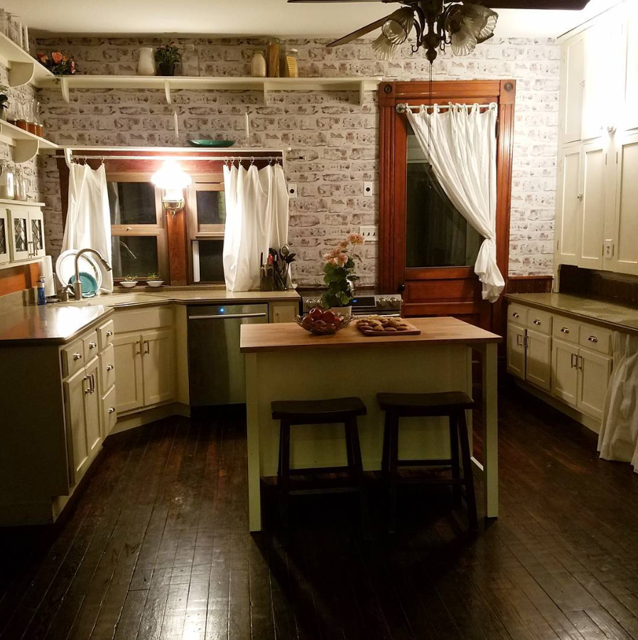 Whitewashed Brick Kitchen with Butcher Block Island