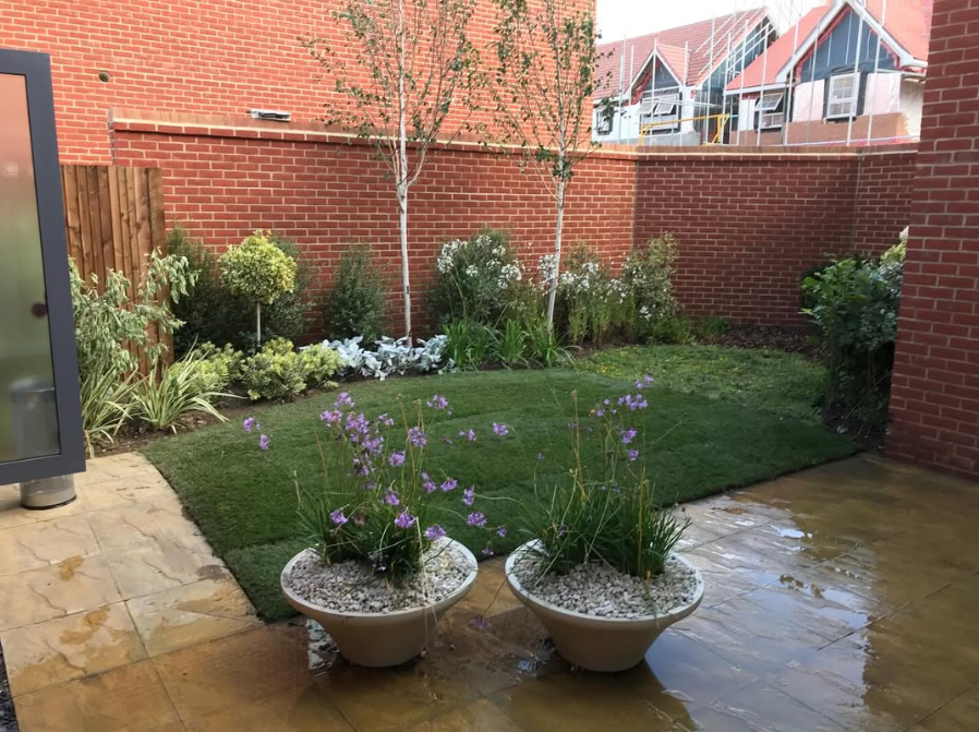 Symmetrical Pots with Lawn and Mixed Border