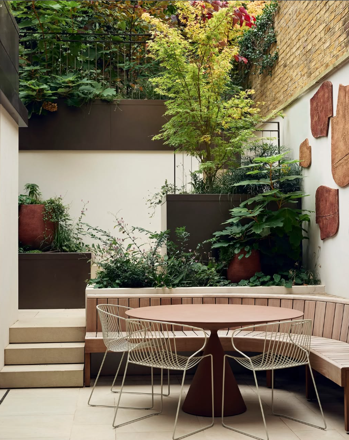 Layered Green Courtyard with Dining Area