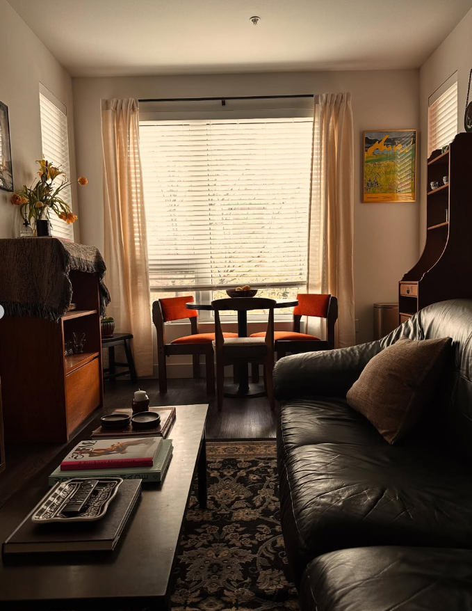Dark and Cozy Studio with Orange Accent Chairs